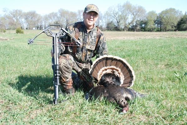 hunter with crossbow and turkey